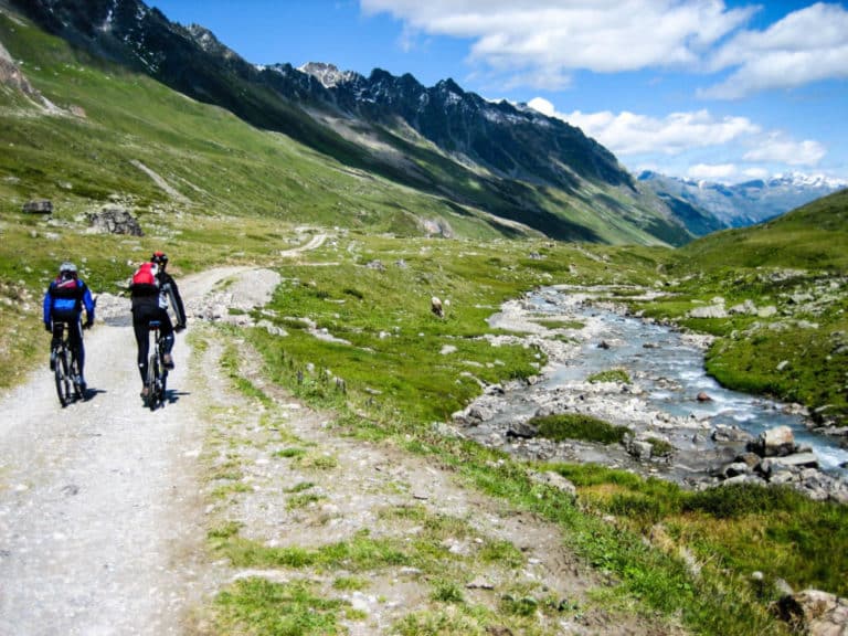 Electric bikes are more than equipped to overcome all types of terrain and slopes. It’s even better if your bike has a mid-drive motor, as these are optimal for quickly managing steep hills. What I’m going to tell you is what features you’re going to want to have on an electric bike that make it suitable for hills. The ebike’s systems are designed to propel itself while climbing steep hills, although the average speed will likely decrease on the ascent. With regenerative braking, battery life can be extended when descending so that the ebike can travel more distance. Many people who buy a gravel bike find it difficult to choose the right accessories for safe riding, such as a good helmet. Modifying the electric assist to help you maintain a steady pedal stroke is just as important as changing gears if you have the option on your e-bike. Most electric bikes with HUB motors have limited gear and speed options, so while they’re great for flats and slight inclines, they don’t do well on major climbs. Keep an eye out for obstacles and terrain changes ahead so you can adjust your line accordingly and maintain a paddling flow while riding uphill on your E MTB. So there you have it, with the right technique you can conquer the steepest hills while riding an electric mountain bike. Hopefully the information we’ve shared has given you a better understanding of what to expect from each of the different options that are available to you while shopping for an electric bike that will do what you need it to do. It should be clear from everything we’ve covered that even the most basic hub motor electric bike will do better hill climbs for you than it can do with pedal power alone. True story – I once rode my bikes all the way from central California to Tijuana, Mexico to enjoy some tacos with my friend Rob. So, you may be wondering if electric Go-bikes can go uphill before you make the decision to buy one. By choosing the right setup, pedal assist e-bikes will only kick when you’re pedaling, giving you better control over the total power you need to complete your climb. Through the gearing systems, the e-bike can be propelled up steep hills and when doing this, the average speed will be quite low. Ideally, when climbing a hill, use a lower mechanical gear and a higher electric assist gear to get the optimum amount of power to keep the bike moving forward.